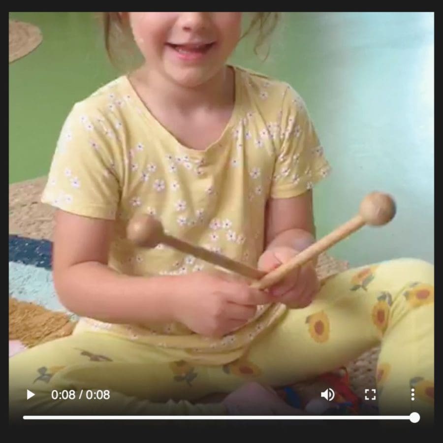 Encouraging children to share their favourite songs in the languages spoken at home. One child sings a song her father sings to her in Italian.